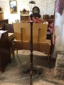 A 19thc style floor lamp with reeded and carved stem on tripod support ending in ball and claw