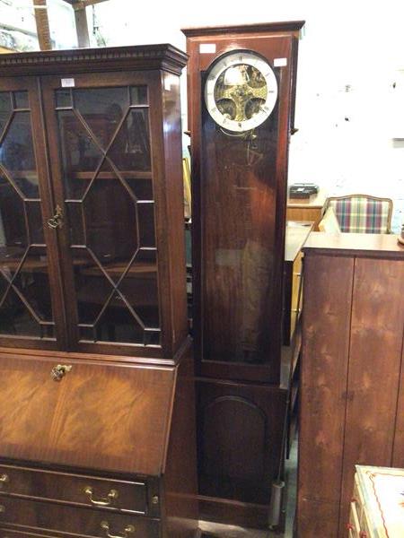 A latter half of the 20thc. longcase clock with the glass fronted door and circular dial with