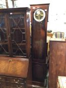 A latter half of the 20thc. longcase clock with the glass fronted door and circular dial with