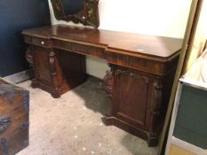 A 19thc mahogany sideboard, the inverted breakfront top with three frieze drawers, on two pedestals,