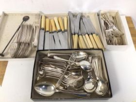 A quantity of cutlery including knives, forks, fish knives, bone handled knives, table spoons,