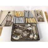 A quantity of cutlery including knives, forks, fish knives, bone handled knives, table spoons,