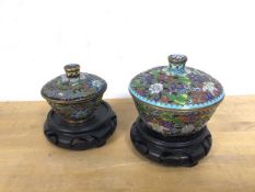 Two cloisonne lidded bowls (larger: 9cm), with two pierced wooden stands, in foliate pattern