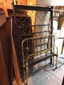 An Edwardian bed frame, with brass rail, headboard and footboard and sprung chain base (headboard: