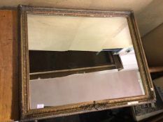An Edwardian wall mirror, the rectangular glass within a gilt composition frame of Classical