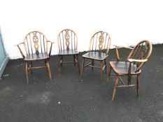 A matched set of four dining chairs with hoop backs above a pierced splat with a stylised fleur de