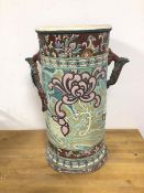 An early 20thc ceramic umbrella stand with handles to side and foliate decoration (40cm)