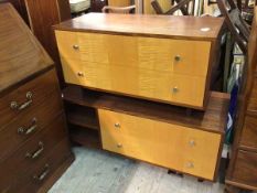 Two mid century low units, in teak and satinwood, the larger with pair of drawers and two recesses