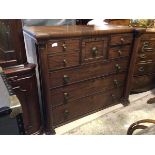 A 19thc mahogany chest of drawers, the inverted top above a central square drawer, flanked by a