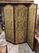 A large Edwardian three fold screen, each panel with arched top and foliate pattern fabric to either