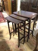 A 1930s/40s set of mahogany nesting tables, with bowed fronts and moulded edges, on square