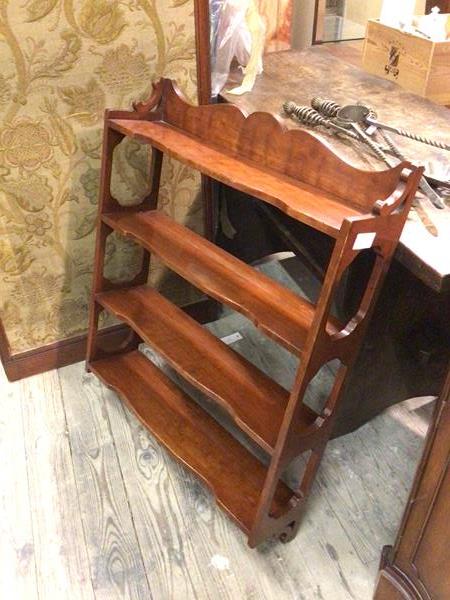 A modern wall shelf, with moulded ledge back above four shelves, with pierced supports (90cm x