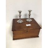A pair of silver weighted candlesticks of baluster form (each 12.5cm) and a pine box
