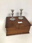 A pair of silver weighted candlesticks of baluster form (each 12.5cm) and a pine box