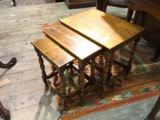 A set of three oak nesting tables, on turned supports united by stretchers (largest: 40cm x 41cm x