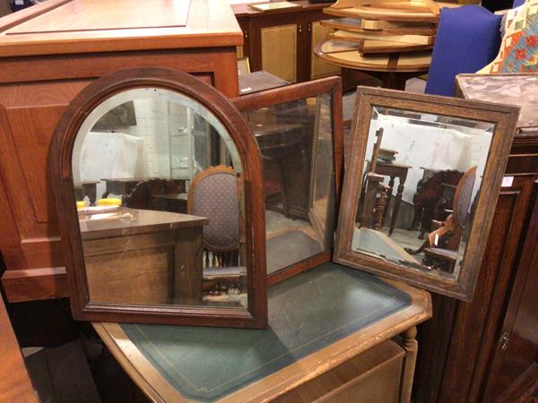 A group of three wall mirrors, two in rectangular frames, one in a domed frame (53cm x 42cm)