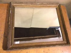 An Edwardian wall mirror, the rectangular glass within a gilt moulded frame (61cm x 70cm)