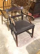 A Regency mahogany armchair, the top rail with scroll top above a carved back rail, flanked by