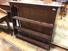 A 1920s/30s plate rack, the moulded cornice above a moulded and pierced apron, with three plate