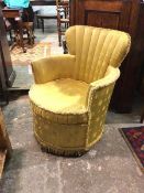 A modern boudoir chair, the fan back above curved arms and circular seat in a yellow snowflake