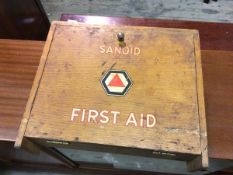 A vintage First Aid cabinet, inscribed Sanoid, with fall front enclosing a fitted interior, on