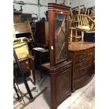 A reproduction Georgian style corner cabinet, the moulded dentil cornice above a glazed door,