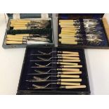 Three boxed sets of cutlery, all with bone handles, including forks and fish knives (a lot)