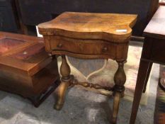 A mid 19thc games/work table, the walnut top with hinged serpentine top over a games table, with