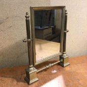 An early 20thc brass dressing table mirror, the hinged rectangular mirror on plinth base (41cm x