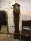 A Georgian style grandmother clock, the arched top above a hinged door, before a dial with roman