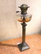 An Edwardian oil lamp, the cut glass reservoir on a Corinthian column body, stamped Evereds (54cm)