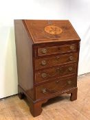 A small inlaid mahogany bureau in the Sheraton taste, late 19th century, the slant front inlaid with