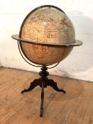 An Edwardian floor-standing terrestrial library globe, the printed map with maker's cartouche "