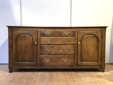 An 18th century oak country dresser, the twin plank rectangular top over four graduated drawers,