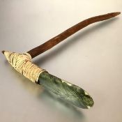 Papua, New Guinea, an adze with a flat greenstone blade, fibre binding and a wooden handle. 48cm