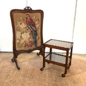 A William IV rosewood firescreen, the moulded undulating frame with floral pierced carved crest rail