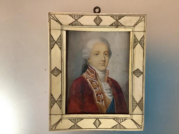 A portrait miniature of a young gentleman in 18th century dress, depicted in red coat and powdered