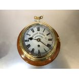 An early 20th century Prescot Clock Co. brass bulkhead clock, with eight-day movement, white