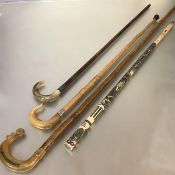A group of late 19th/early 20th century walking sticks and canes comprising: a lady's stick with