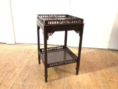 A two-tier occasional table of Chippendale design, early 20th century, each tier with fret-carved