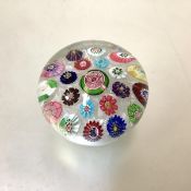 A 19th century paperweight, probably Clichy, with scattered flower canes centred by a pink rose,