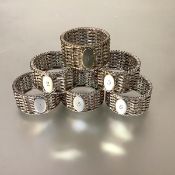 A set of six silver-plated napkin rings, c. 1900, each circular and of basket-weave design, numbered