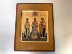 Russian School, 19th Century, an icon depicting three saints, against a gold ground, oil on panel.