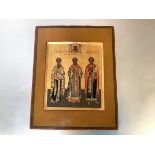 Russian School, 19th Century, an icon depicting three saints, against a gold ground, oil on panel.