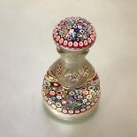 A millefiori paperweight inkwell of domed form, with concentric canes in multiple colours, cased