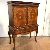 A walnut cabinet on stand, early 18th century and later, the projecting moulded cornice over a