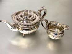 A handsome George III silver two piece partial tea service, comprising teapot and cream jug,