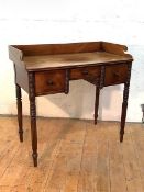 A Regency mahogany dressing table, with shaped three-quarter gallery around a rectangular top and