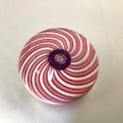 A small 19th century spiral paperweight, probably Clichy, the central flower pattern canes in pink