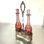 A German electroplated double decanter stand with a pair of cut-glass decanters, c. 1900, the